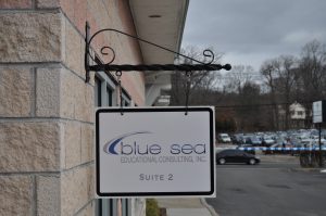 Wilson Wayfinding Signs outdoor hanging blade sign blue sea building business wayfinding address sign 300x199